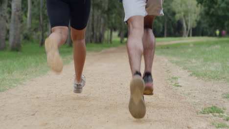 Closeup-of-fit-couple-legs-running-on-a-forest