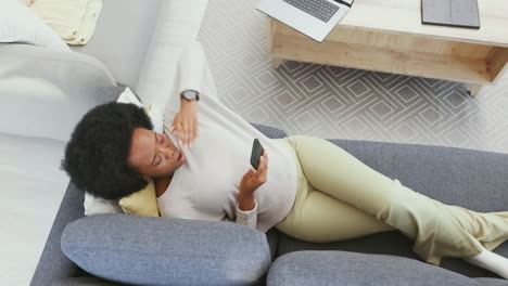 Relaxed-woman-using-a-phone-to-browse-online