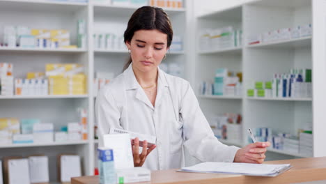 A-female-pharmacist-or-clerk-working-behind