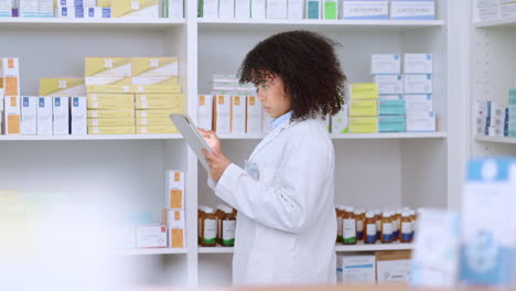 Young-and-focused-pharmacist-use-her-tablet-to-do