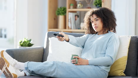 Black-woman-watching-tv,-having-coffee