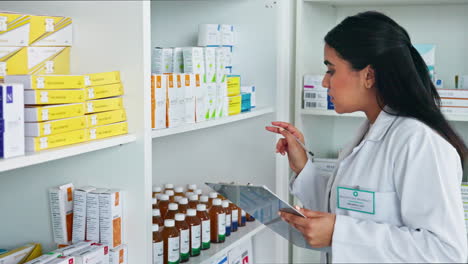 Pharmacist-checking-clipboard-for-medication-pills