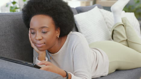 African-woman-scrolling-on-a-digital-tablet