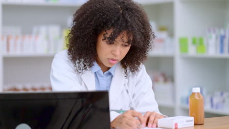 Young-and-busy-pharmacist-checking-her-computer