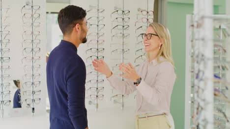 Friendly-optician-fitting-a-pair-of-glasses