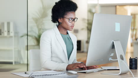 African-female-financial-manager-writing-notes