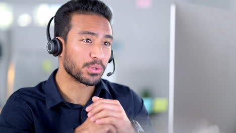 Call-center-agent-talking-on-headset-while-working
