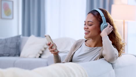 Woman-listening-to-music-on-her-phone-using