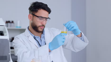 Serious-male-scientist-analyzing-liquid