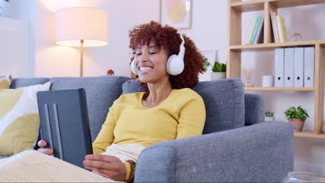 African-adult-woman-video-call-at-home-on-sofa