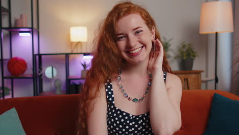 Close-up-of-happy-beautiful-teenager-redhead-freckles-woman-smiling-looking-at-camera-at-home