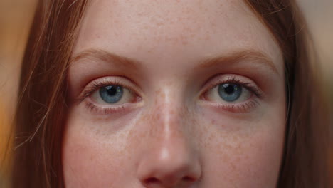 Close-up-macro-portrait-of-freckles-child-kid-face-smiling,-teen-blue-girl's-eyes-looking-at-camera