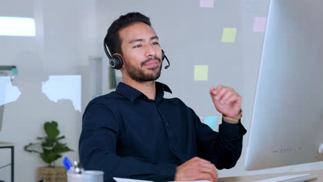Male-call-centre-agent-talking-on-headset