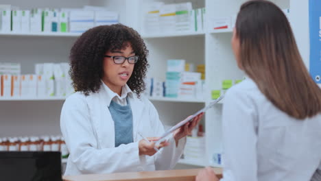 Patient-signing-up-to-buy-medicine-from-pharmacist