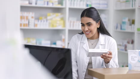Pharmacist-working-on-computer-at-a-pharmacy