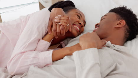 Couple-smile,-happy-and-hug-while-in-bed-together