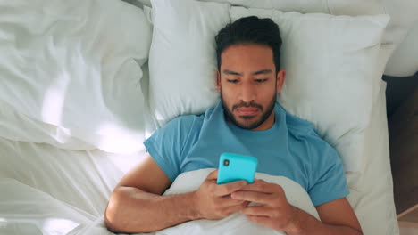Man-in-bed-with-phone-or-smartphone