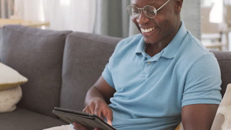 Funny,-tablet-and-black-man-on-sofa-with-social