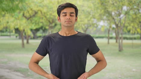 Indian-boy-doing-breathe-in-breathe-out-exercise