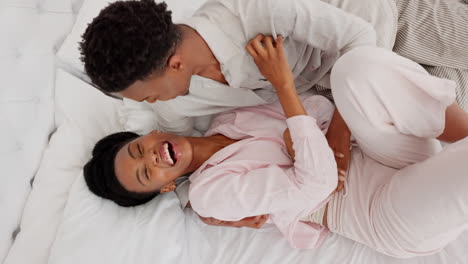 Love,-black-couple-and-bedroom-fun-while-laughing
