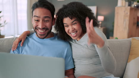 Happy-and-excited-couple-with-a-laptop-on-a-video