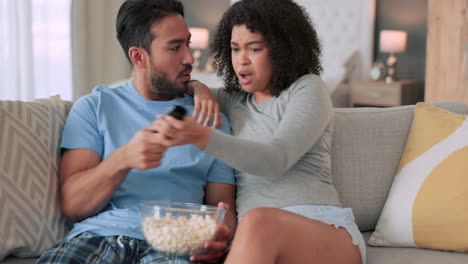 African-couple-fight-over-remote-for-tv-movie