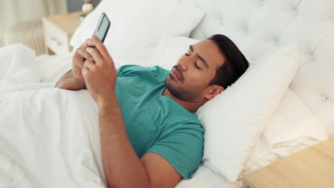 Morning,-phone-and-man-texting-in-bed-relaxing