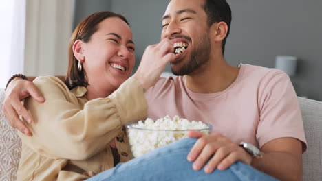 Popcorn,-eating-and-love-with-a-couple-laughing