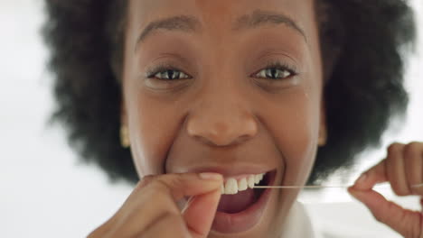 Black-woman-afro,-flossing-teeth