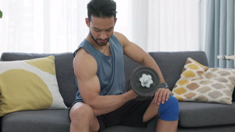 Fitness,-dumbbell-and-biceps-of-a-man-on-sofa
