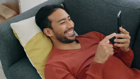 Social-media,-relax-and-man-texting-on-sofa