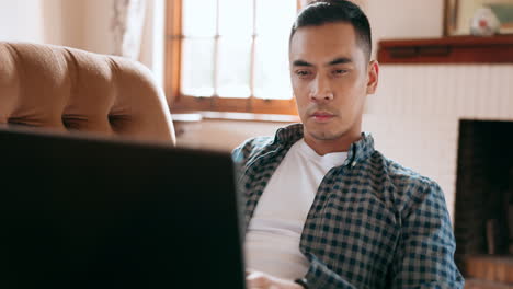 Asian-man,-laptop-or-thinking-on-house-living-room