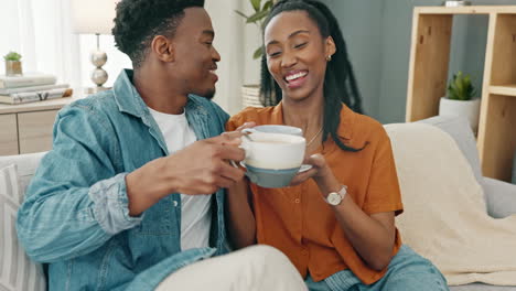 Coffee,-relax-and-black-couple-on-sofa-in-home