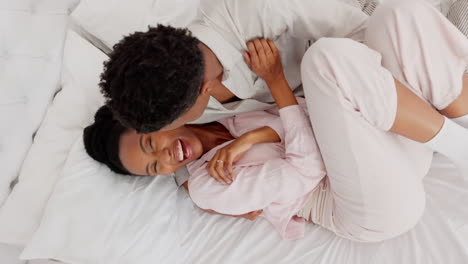 Happy-fun-black-woman-and-man-kiss-in-bed-at-home