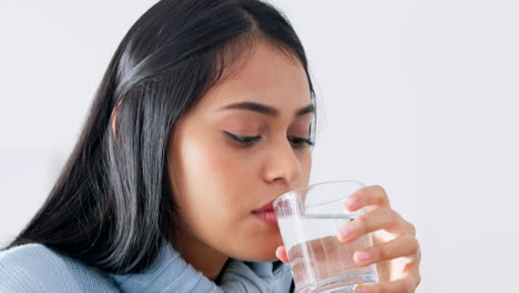 Woman-drink-glass-of-water-for-health-in-house