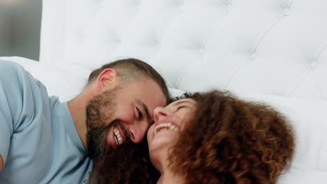Funny,-crazy-and-playful-couple-in-bed-laughing