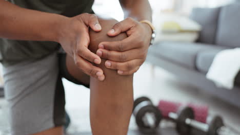 Hands,-health-and-black-man-with-knee-pain-in-home
