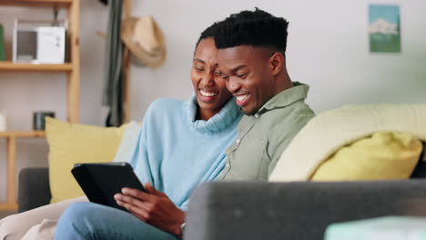 Couple,-digital-tablet-and-sofa-with-happy