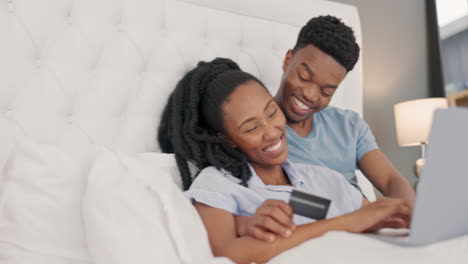 Bed,-credit-card-and-couple-online-shopping