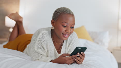 Bed,-phone-and-a-black-woman-surfing-social-media