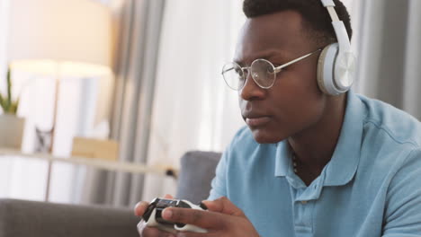 Video-game,-headphones-and-gamer-man-on-sofa