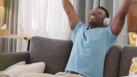 Man,-winning-or-video-game-success-on-sofa