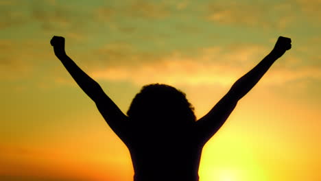 Silhouette,-sunset-and-celebration-woman