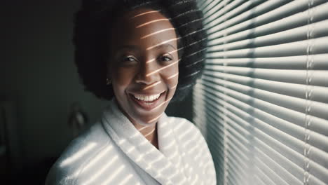 Black-woman,-morning-sun-in-blinds