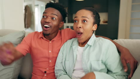 Excited-black-couple-watch-television