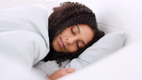 Young-black-woman-sleeping-in-bed-in-her-bedroom