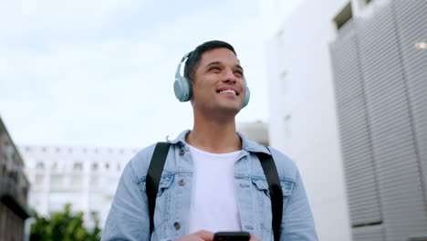 Happy,-headphones-and-phone-of-a-man-in-the-city