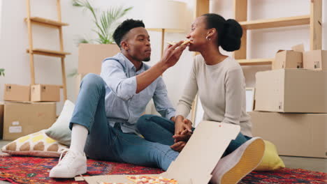 Black-couple-eating-pizza-in-new-house
