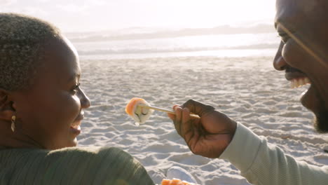 Happy-black-couple,-sushi-and-beach-picnic-eating