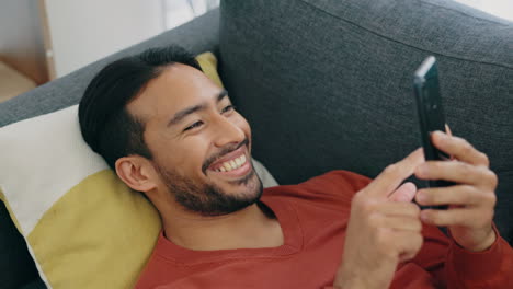 Sofa,-happy-and-relax-man-with-phone-scroll
